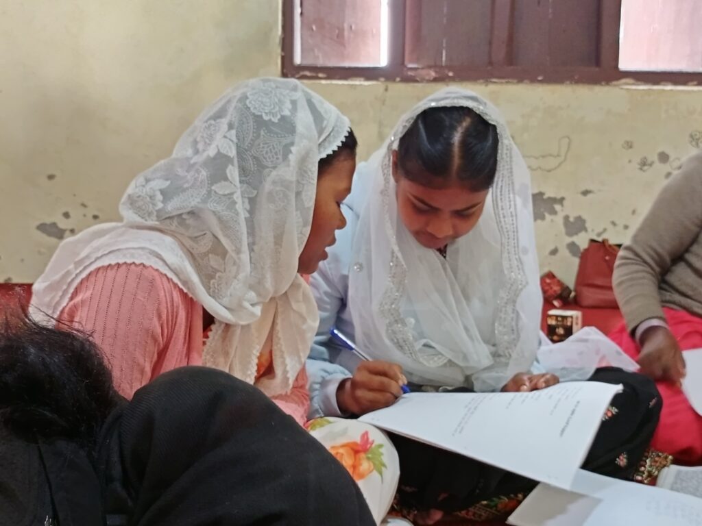 A woman training another woman how to train others using the Training for Trainers method.