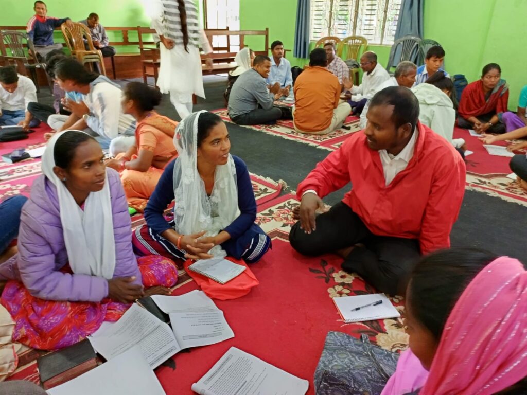 A photo showing a group of Christian people discussing the bible.
